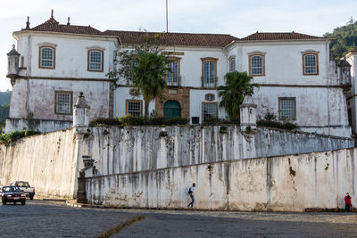 Street by buildings in town against sky