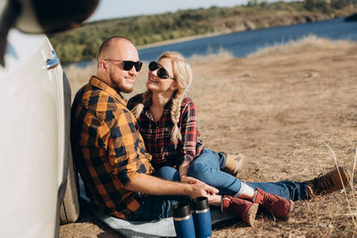 Young couple sitting on land