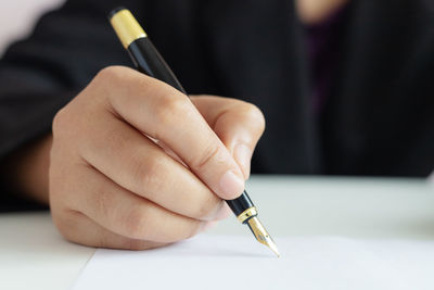 Close-up of hand holding paper