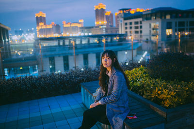 Young woman sitting outdoors