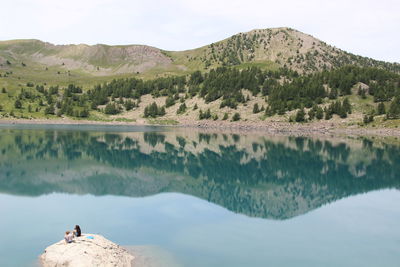 Scenic view of lake with mountains in background