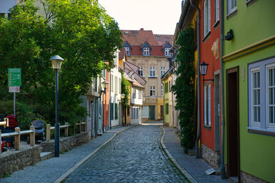 Empty alley amidst buildings in city