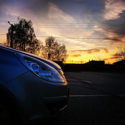 Car on road against sky at sunset