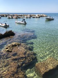 Boats in sea against sky