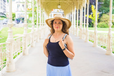 Portrait of woman wearing hat standing outdoors