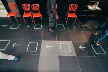 Low section of people standing on tiled floor