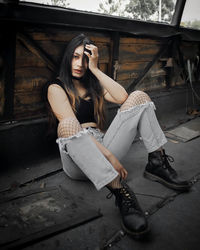 Portrait of a young woman sitting outdoors