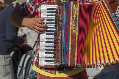 Midsection of man playing piano