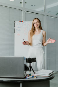 Young woman giving presentation in office