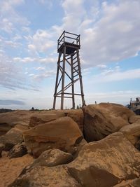 Low angle view of rock formation on land against sky