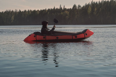 Boat trip on packraft in a picturesque beautiful lake or river. active recreation on the water.