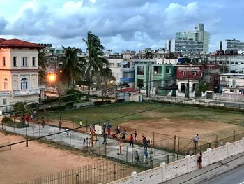 High angle view of people on street amidst buildings in city