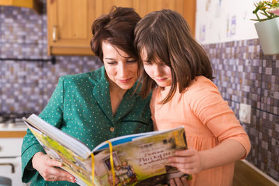 Young woman looking at book