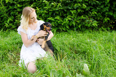 Woman with dog on field