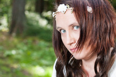 Close-up portrait of mature woman wearing flower wreath