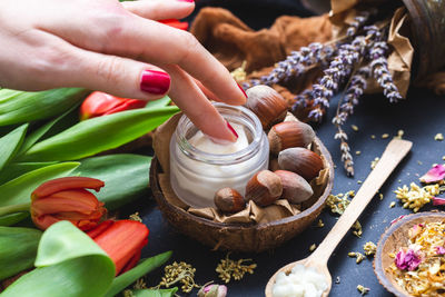 Midsection of woman holding food on table