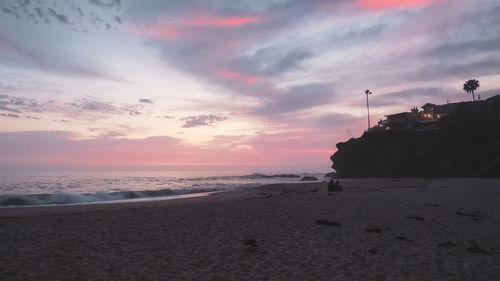 Scenic view of beach against sky during sunset