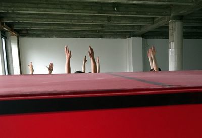 Group of people against red wall