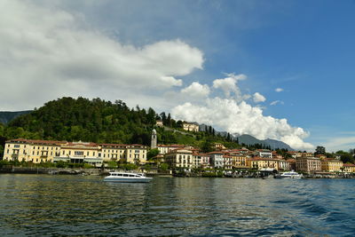 View of townscape by sea against sky