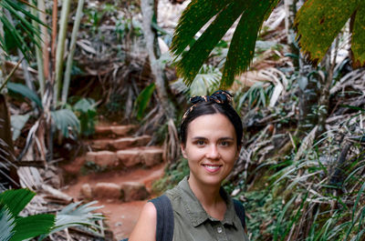 Portrait of an attractive young woman in tropical forest.