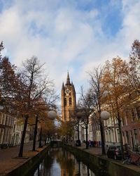 River amidst trees and buildings against sky