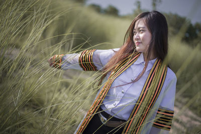 Young woman standing on field