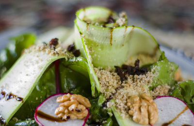 Salad with walnuts, greens and vegetables, close-up