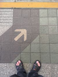 Low section of man standing on street