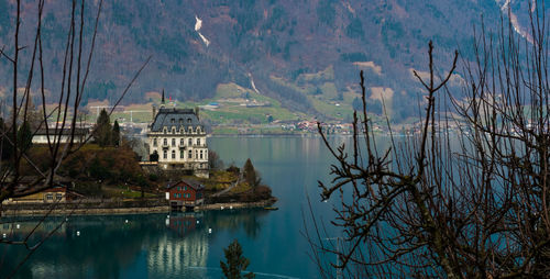 Reflection of trees and buildings in lake