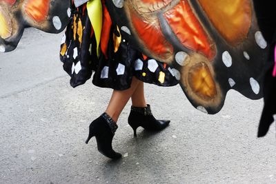 Low section of woman walking on road