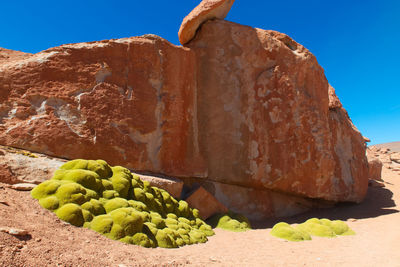 Rock formation against sky on sunny day