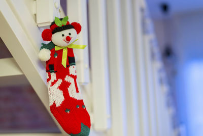 Close-up of red toy hanging on railing