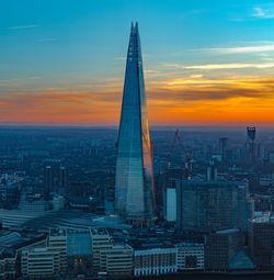 Aerial view of buildings in city during sunset