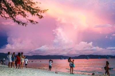 People on beach at sunset