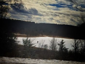 Scenic view of lake against cloudy sky