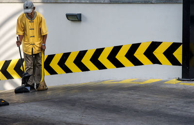 Man working on zebra crossing in city