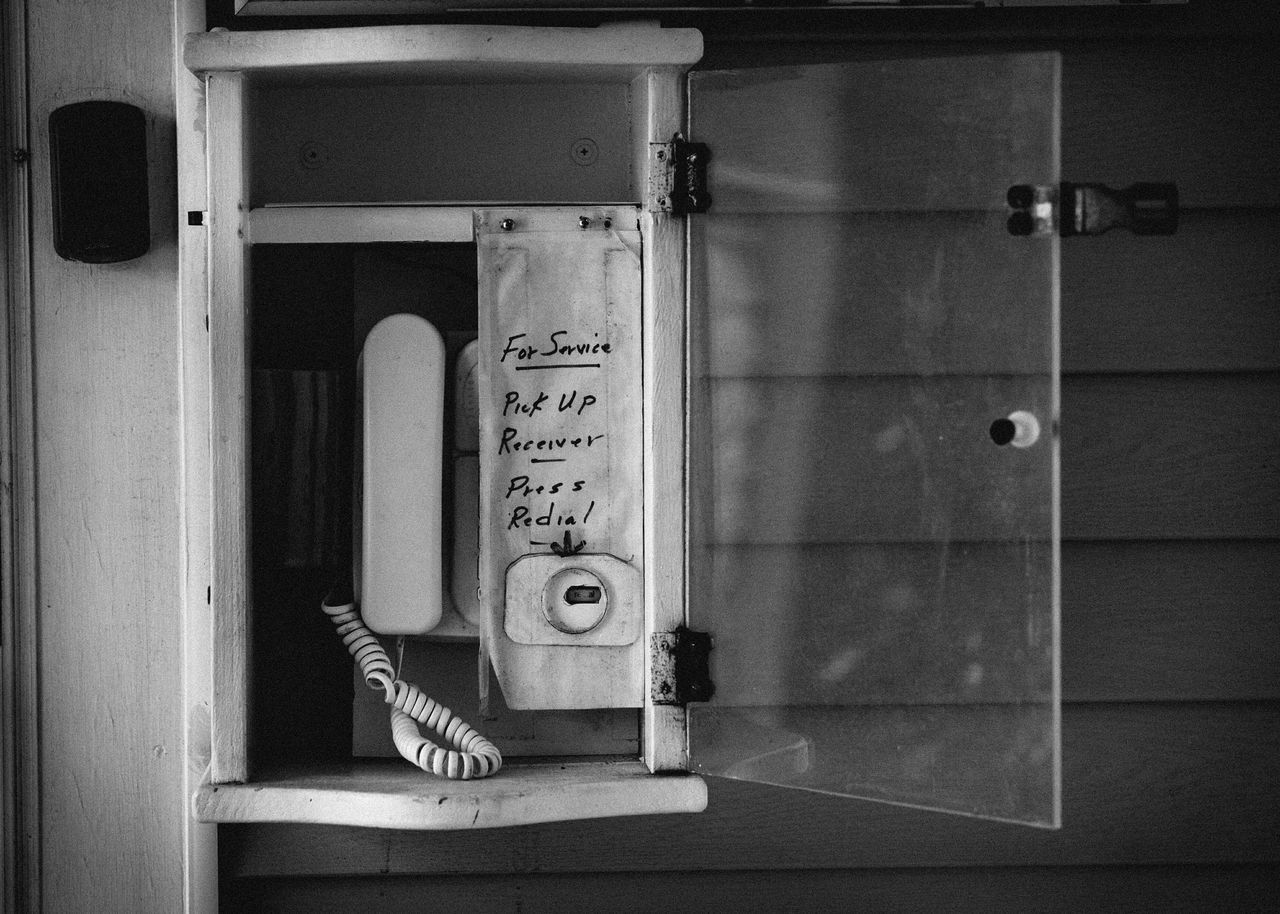 indoors, communication, text, wall - building feature, western script, door, wall, close-up, number, wood - material, no people, built structure, white color, architecture, still life, non-western script, day, closed, table, hanging