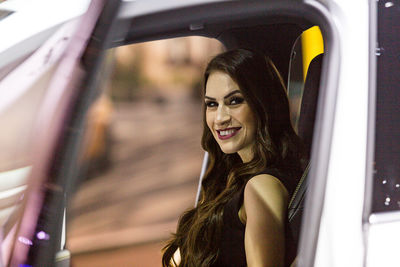 Portrait of young woman in car