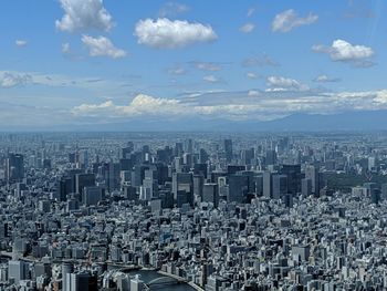 Aerial view of city buildings against sky