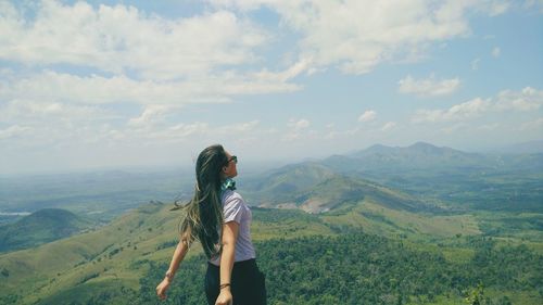 Woman standing against mountains