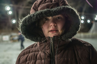 Close-up portrait of smiling young woman in winter