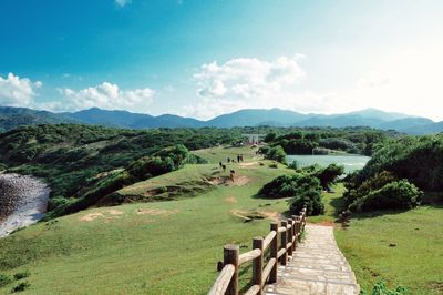 Scenic view of landscape against cloudy sky