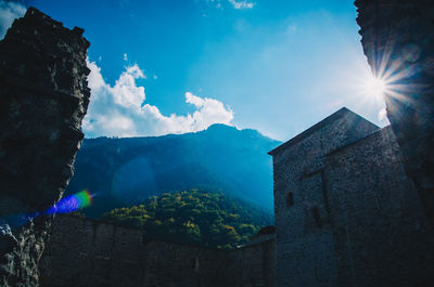 Building against mountains in sunny day