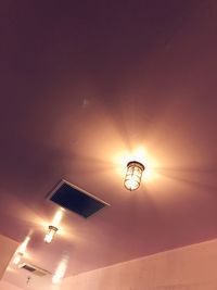 Low angle view of illuminated street light at night