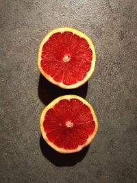 Directly above shot of halved grapefruit on table