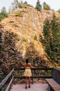 Rear view of woman sitting on staircase