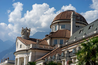 Low angle view of buildings in town against sky