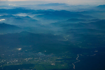 Aerial view of mountain range against sky