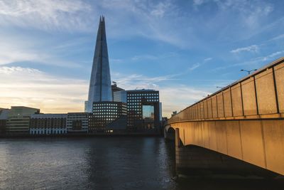 View of bridge over river against cloudy sky