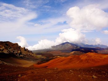 Scenic view of mountains against cloudy sky